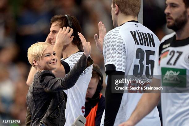 Reporter Anett Sattler reacts after the Handball international friendly match between Germany and Denmark at Lanxess Arena on April 2, 2016 in...