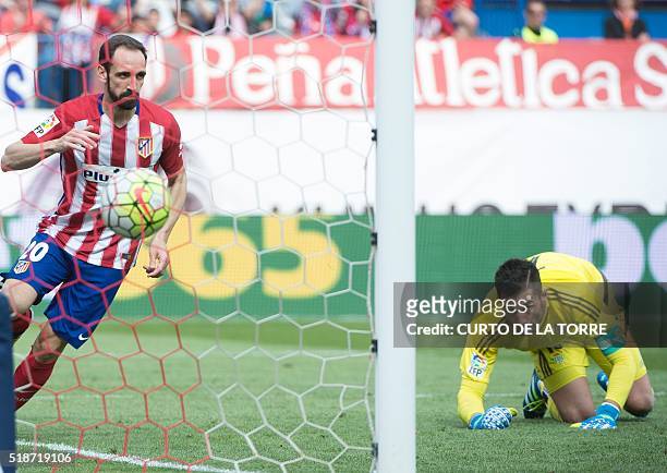 Atletico Madrid's defender Juanfran scores during the Spanish league football match Club Atletico de Madrid vs Real Betis Balompi at the Vicente...