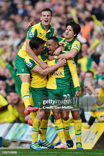 Martin Olsson of Norwich City celebrates scoring his team's third goal with his team mates during the Barclays Premier League match between Norwich...