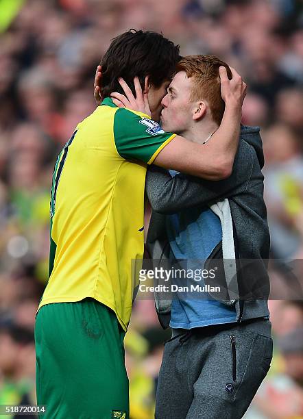 Pitch invader kisses Timm Klose of Norwich City during the Barclays Premier League match between Norwich City and Newcastle United at Carrow Road on...