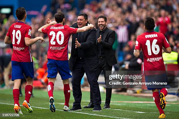 Juan Francisco Torres alias Juanfran of Atletico de Madrid celebrates scoring their third goal with assistant coach German Burgos , coach Diego Pablo...