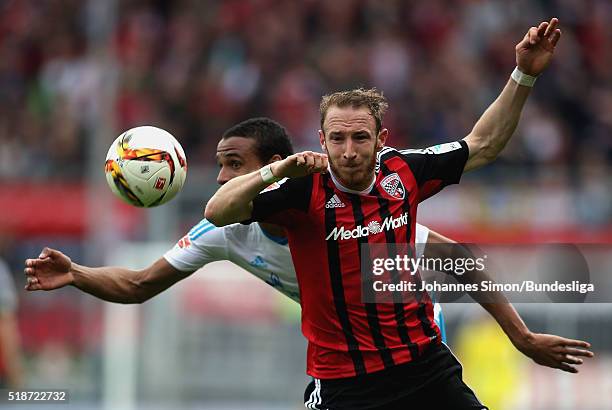 Moritz Hartmann of Ingolstadt fights for the ball with Joel Matip of Schalke during the Bundesliga match between FC Ingolstadt and FC Schalke 04 at...