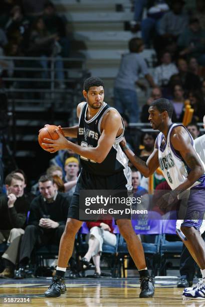 Tim Duncan of the San Antonio Spurs is defended by Joe Smith of the Milwaukee Bucks during the game on December 4, 2004 at the Bradley Center in...