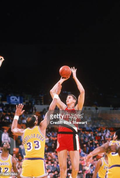 Sam Bowie of the Portland Trail Blazers shoots over Kareem Abdul-Jabbar of the Los Angeles Lakers during a game circa 1984-1988 at the Great Western...