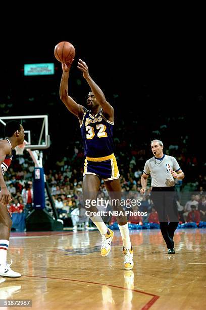 Magic Johnson of the Los Angeles Lakers makes a pass against the Washington Bullets during the NBA game in Washington, D.C. NOTE TO USER: User...