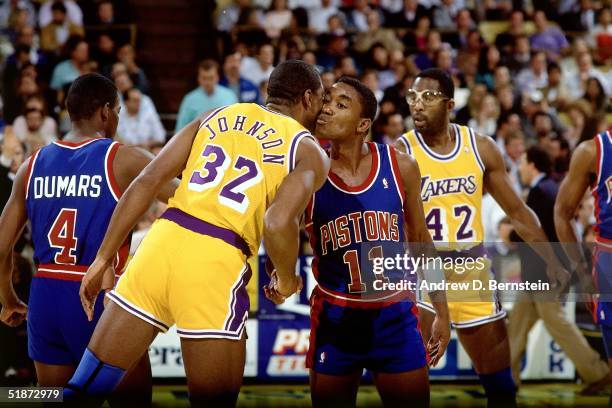 Magic Johnson of the Los Angeles Lakers and Isiah Thomas of the Detroit Pistons shake hands at center court prior to the NBA game at the Forum in Los...