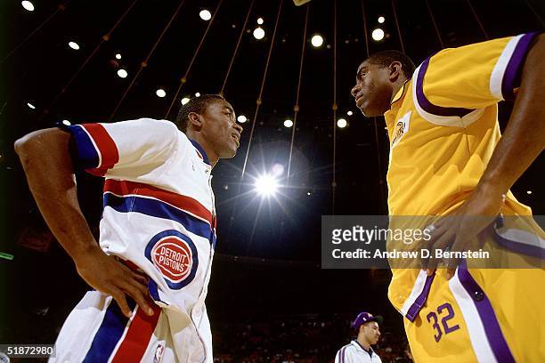 Isiah Thomas of the Detroit Pistons and Magic Johnson of the Los Angeles Lakers meet at center court prior to the NBA game at the Forum in Los...