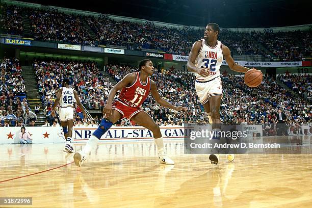 Magic Johnson of the Western Conference All-Stars looks to make a play against the Eastern Conference All-Stars during the 1986 NBA All-Star Game on...