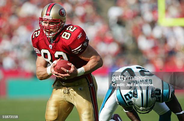 Tight end Eric Johnson of the San Francisco 49ers runs upfield past cornerback Chris Gamble of the Carolina Panthers at Monster Park on November 14,...