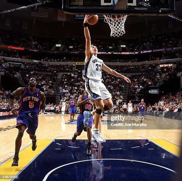 Mike Miller of the Memphis Grizzlies takes the ball to the basket during the game against the New York Knicks at FedExForum on December 7, 2004 in...