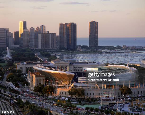 General view of the New Soldier Field Stadium with the Chicago skyline background filed with a warm light from the sun prior to a game between the...