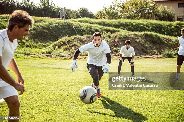 goalkeeper training - boy in hard hat stock-fotos und bilder