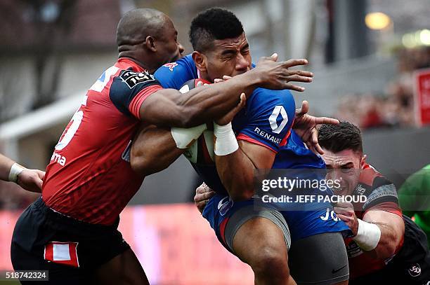 Grenoble's Fidjian wing Maritino Nemani is tackled by Oyonnax' Ivorian wing Silvere Tian and Oyonnax' Irish centre Eamonn Sheridan during the French...