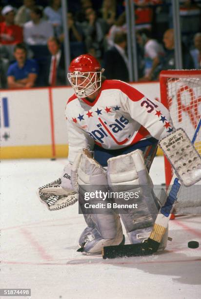 American professional hockey player Bob Mason, goalie for the Washington Capitals, tends the goal during warm-up before a home game at the Capital...