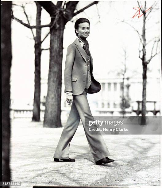 Chantal Dumont wearing a pant suit with a vest, ascot tucked into her paisley shirt by Cerruti.