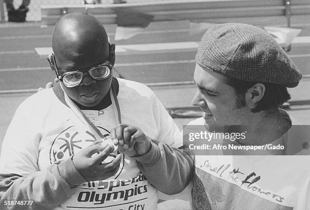 Athletes and volunteer during the Special Olympics, Maryland, 1995.