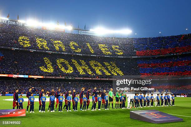 Fans unveil a mosaic tribute to the former FC Barcelona player and manager, Johan Cruyff as the players shake hands before the La Liga match between...