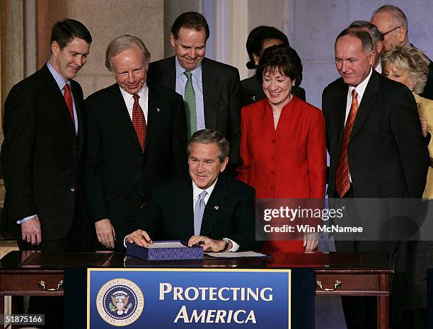 President George W. Bush prepares to sign the intelligence reform bill into law with Sen Bill Frist , Sen Joe Lieberman , 9-11 Commission Chairman...