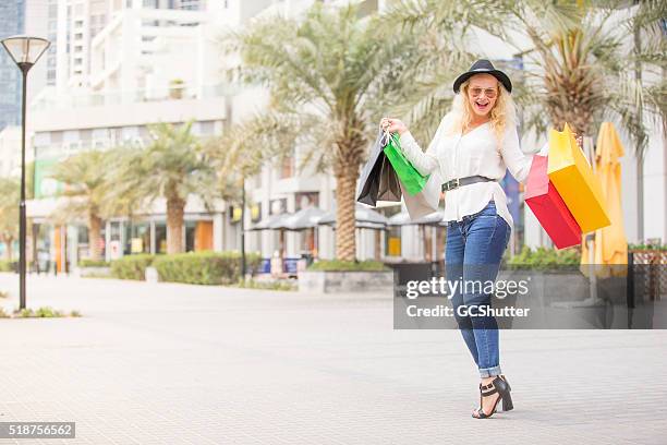 attractive girl holding her shopping bags - dubai shopping stock pictures, royalty-free photos & images