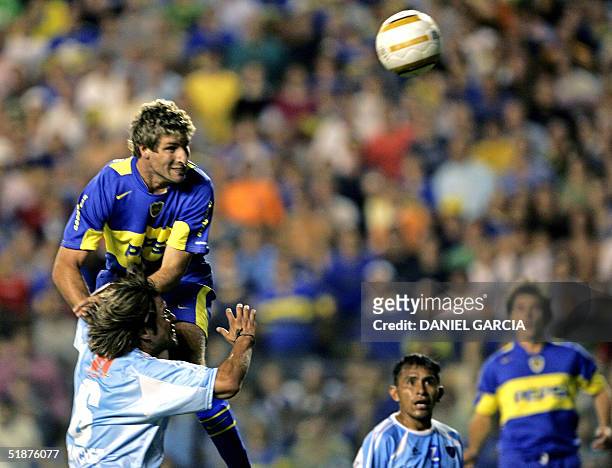 Martin Palermo of Boca Juniors of Argentina jumps over Oscar Sanchez of Bolivar de La Paz, from Bolivia, and heads the ball to score the first goal...