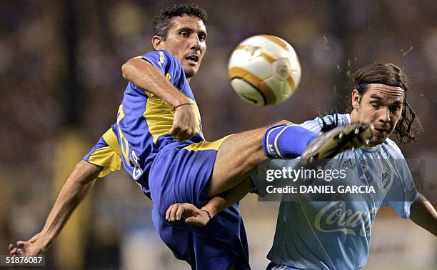 Diego Cagna of Boca Juniors of Argentina and Ruben Tufino of Bolivar of La Paz, Bolivia, vie for the ball during their final Copa Sudamericana match...