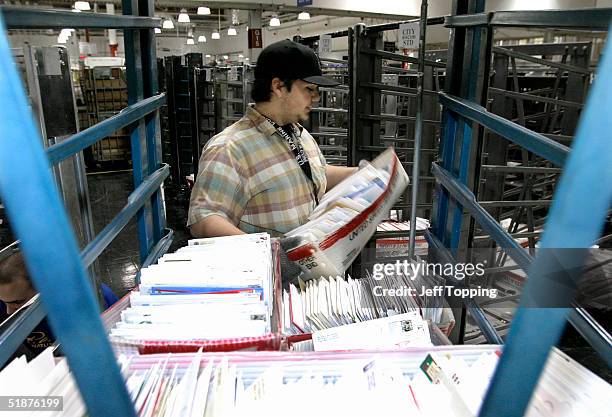 Post Office mail clerk Jesse Preston moves letters from a cart to a sorting area at the Phoenix Processing and Distribution center December 17, 2004...