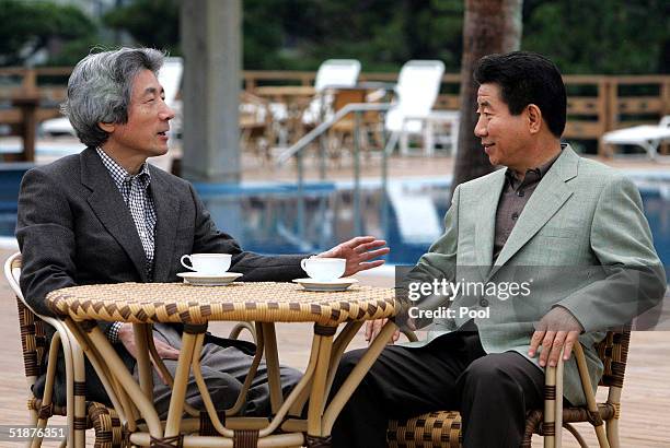 South Korean President Roh Moo-hyun takes a stroll with Japanese Prime Minister Junichiro Koizumi at a hot springs resort on December 18, 2004 in...