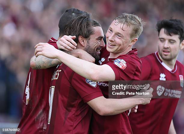 Ricky Holmes of Northampton Town celebrates with team mate Nicky Adams after scoring his and his sides first goal during the Sky Bet League Two match...