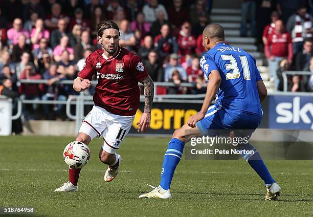 Ricky Holmes of Northampton Town looks to play the ball past Thierry Audel of Notts County during the Sky Bet League Two match between Northampton...