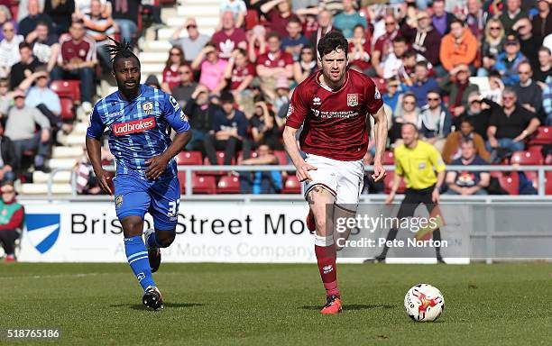 Brendan Moloney of Northampton Town moves forward with the ball away from Stanley Aborah of Notts County during the Sky Bet League Two match between...