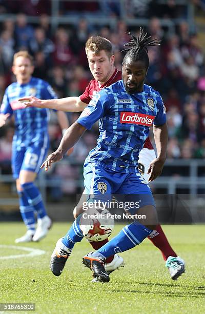 Stanley Aborah of Notts County controls the ball watched by James Collins of Northampton Town during the Sky Bet League Two match between Northampton...