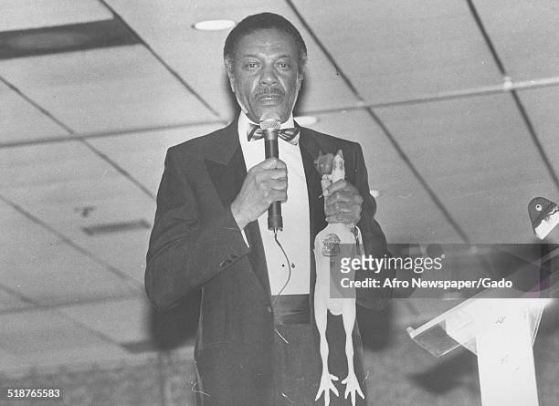 First African-American police commissioner of Baltimore, Maryland Bishop Robinson speaking into a microphone, 1975.
