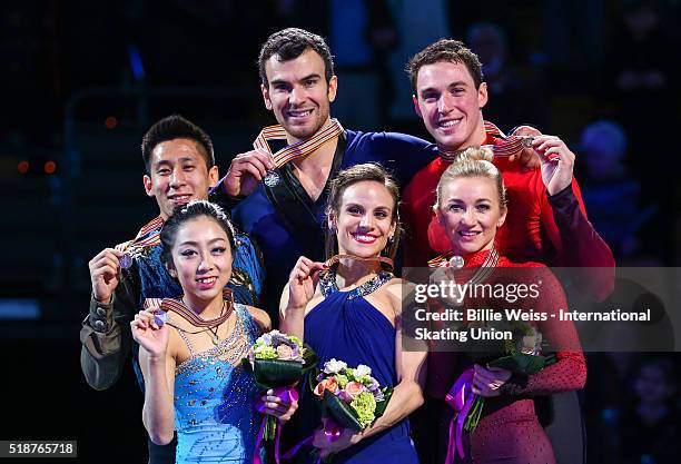 Medal ceremony is held for the pairs free skating final with gold medalists Meagan Duhamel and Eric Radford of Canada, silver medalists Wenjing Sui...