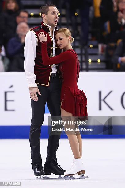 Tatiana Volosozhar and Maxim Trankov of Russia react after completing their routine in the Pairs Free Skate on Day 6 of the ISU World Figure Skating...