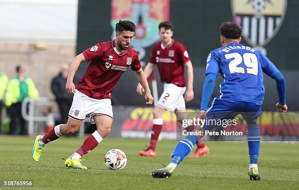 Danny Rose of Northampton Town moves forward with the ball watched by Wes Atkinson of Notts County during the Sky Bet League Two match between...