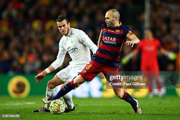 Andres Iniesta of FC Barcelona shields the ball from Gareth Bale of Real Madrid CF during the La Liga match between FC Barcelona and Real Madrid CF...