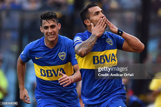 Carlos Tevez of Boca Juniors celebrates with his teammate after scoring the first goal of his team during a match between Boca Juniors and Atletico...