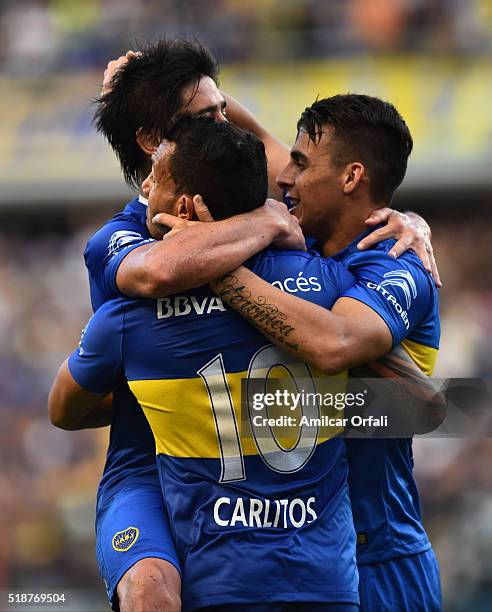 Carlos Tevez of Boca Juniors celebrates with teammates after scoring the first goal of his team during a match between Boca Juniors and Atletico...