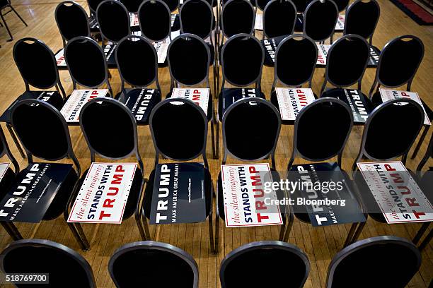 Campaign signs sit on chairs ahead of an event with Donald Trump, president and chief executive of Trump Organization Inc. And 2016 Republican...