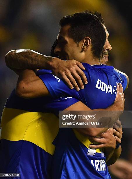 Nicolas Lodeiro of Boca Juniors celebrates with teammates Carlos Tevez and Federico Carrizo after scoring the third goal his team during a match...