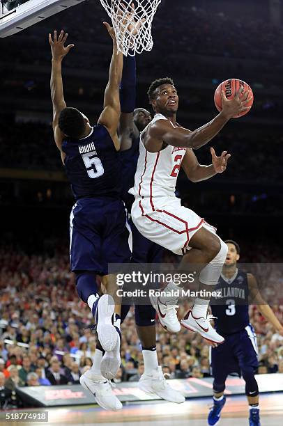 Buddy Hield of the Oklahoma Sooners drives to the basket against Phil Booth of the Villanova Wildcats in the first half during the NCAA Men's Final...