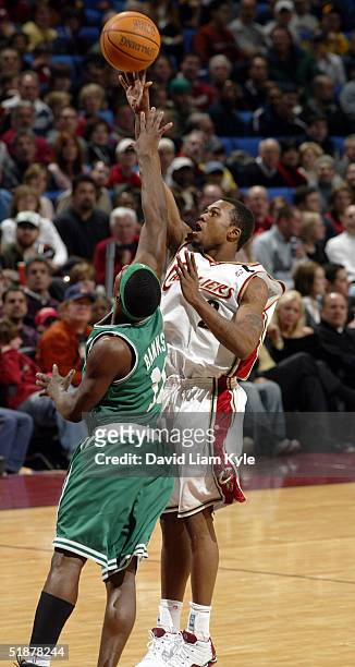 Dajuan Wagner of the Cleveland Cavaliers takes a shot over Marcus Banks of the Boston Celtics on December 18, 2004 at Gund Arena in Cleveland, Ohio....