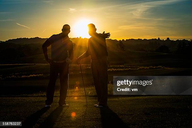 golf pro teaching male golfer - golf lessons stock pictures, royalty-free photos & images