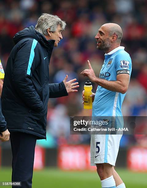 Manuel Pellegrini manager of Manchester City speaks with Pablo Zabaleta of Manchester City during the Barclays Premier League match between AFC...