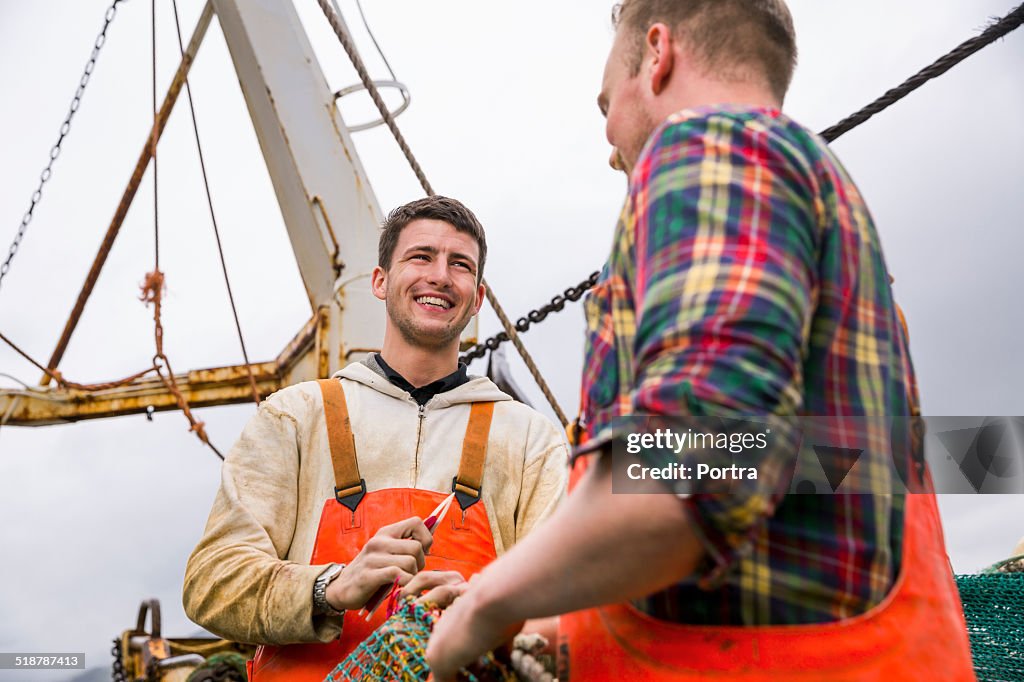 Fisherman talking on fishing boat