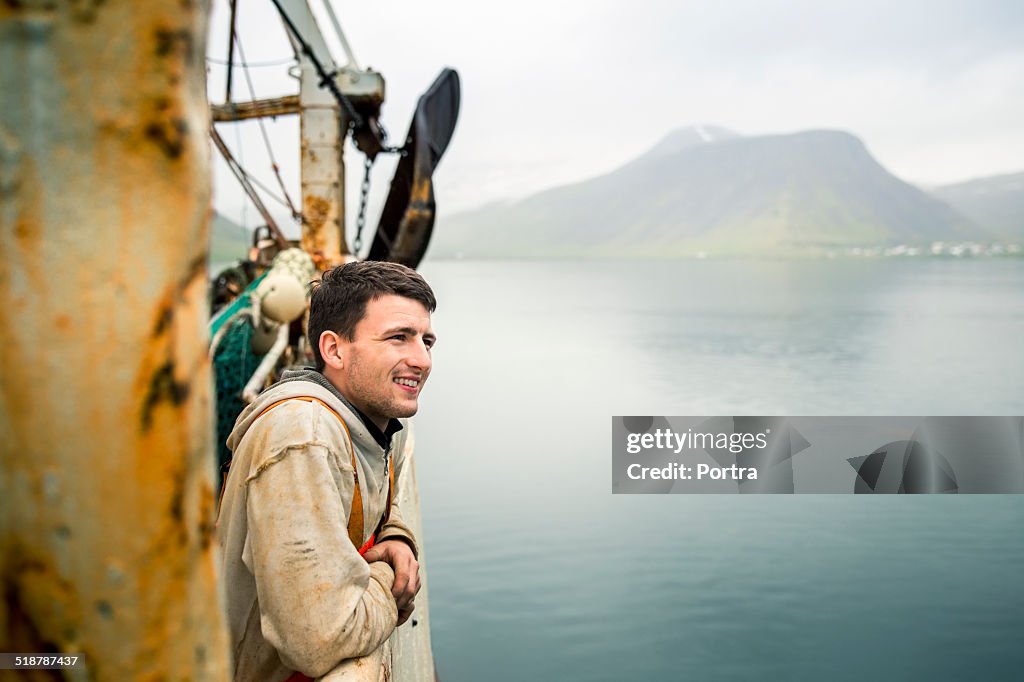 Smiling fisherman on fishing boat