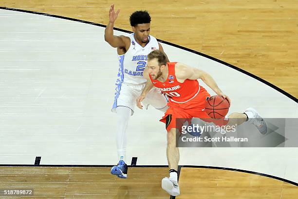Trevor Cooney of the Syracuse Orange drives against Joel Berry II of the North Carolina Tar Heels in the first half during the NCAA Men's Final Four...