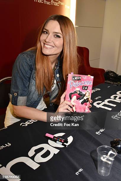 Youtuber Andy Raconte poses with her book during the Youtuber Andy Meets Her Fan At FNAC Bercy in Paris on April 2, 2015 in Paris; France.