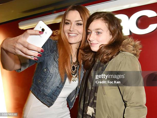 Youtuber Andy Raconte and a guest pose for a selfie during the Youtuber Andy Meets Her Fan At FNAC Bercy in Paris on April 2, 2015 in Paris; France.