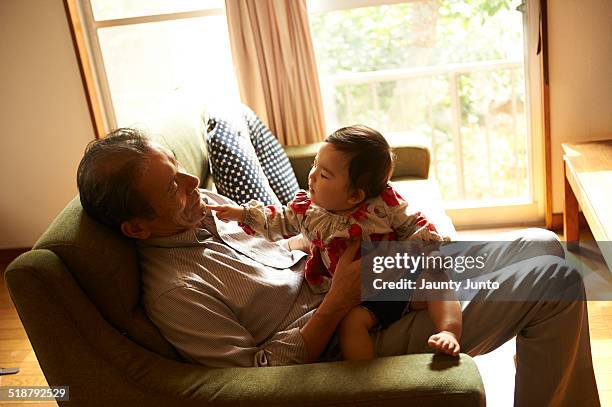 baby touching her grand father - grandfather silhouette stock-fotos und bilder